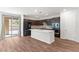 Open-concept kitchen with stainless steel appliances, center island, and sliding glass door to the backyard at 127 Medianoche St, Las Vegas, NV 89138