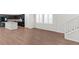 Bright and open living area showcasing hardwood floors and access to the modern kitchen at 127 Medianoche St, Las Vegas, NV 89138