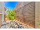 Private backyard showcasing desert landscaping, mature shrubs, and a stylish brick wall at 137 Desert Pond Ave, Henderson, NV 89002