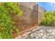 Outdoor patio area featuring a brick wall, foliage and a paved patio space at 137 Desert Pond Ave, Henderson, NV 89002