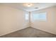 This bedroom features neutral walls and carpet, and natural light from the large window at 137 Desert Pond Ave, Henderson, NV 89002