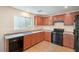 Functional kitchen with a gas range, tiled floors, and wood cabinets at 137 Desert Pond Ave, Henderson, NV 89002