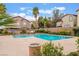 Community pool offers a refreshing escape surrounded by well-maintained landscaping and neighborhood buildings at 137 Desert Pond Ave, Henderson, NV 89002