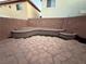 Spacious backyard featuring a raised planting area, flagstone, and block wall fencing at 141 Gryffin Ave, Las Vegas, NV 89123