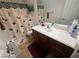 Well-lit bathroom featuring a vanity with dark wood cabinets and a white countertop at 141 Gryffin Ave, Las Vegas, NV 89123