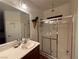 Bathroom featuring a modern sink, quartz countertops, wood laminate floors, and a shower stall at 141 Gryffin Ave, Las Vegas, NV 89123