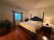 Inviting bedroom featuring hardwood floors, a comfortable bed, and natural lighting at 141 Gryffin Ave, Las Vegas, NV 89123