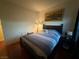 Bedroom with a dark wood bed frame and hardwood floors at 141 Gryffin Ave, Las Vegas, NV 89123