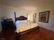 Relaxing bedroom with dark wood bed frame and matching furniture with carpet, great natural light at 141 Gryffin Ave, Las Vegas, NV 89123
