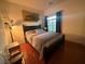 Bedroom featuring hardwood floors and a cityscape art piece hanging above the bed at 141 Gryffin Ave, Las Vegas, NV 89123