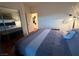 Cozy bedroom featuring a mirrored closet door and an opening to another room at 141 Gryffin Ave, Las Vegas, NV 89123
