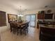 Well-lit dining and kitchen area with tile flooring and plenty of seating for a large group at 141 Gryffin Ave, Las Vegas, NV 89123