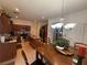Cozy dining area featuring wood table, tile floors, stylish chandelier, and modern stainless appliances at 141 Gryffin Ave, Las Vegas, NV 89123