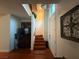 Entryway showcasing the staircase and front door, creating a welcoming atmosphere with hardwood floors at 141 Gryffin Ave, Las Vegas, NV 89123