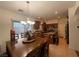 Open concept kitchen with dining area featuring dark wood cabinets and stainless appliances at 141 Gryffin Ave, Las Vegas, NV 89123