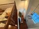 View of wooden staircase leading to the ground floor entryway with natural light and landing above at 141 Gryffin Ave, Las Vegas, NV 89123