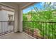 Private balcony with iron railing overlooks lush greenery and hillside views at 1525 Spiced Wine Ave # 10102, Henderson, NV 89074