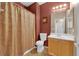 Bathroom featuring earth tone walls, vanity, and shower with patterned curtain at 1525 Spiced Wine Ave # 10102, Henderson, NV 89074