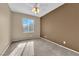 Bedroom showcasing neutral walls, plush carpet, and a ceiling fan at 1525 Spiced Wine Ave # 10102, Henderson, NV 89074