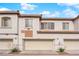Inviting townhouse exterior with a two-car garage and desert landscaping at 1525 Spiced Wine Ave # 10102, Henderson, NV 89074