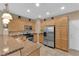 Well-lit kitchen with granite countertops, stainless steel appliances, and light wood cabinets at 1525 Spiced Wine Ave # 10102, Henderson, NV 89074