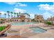 Community pool and jacuzzi area with lounge chairs and palm trees in a landscaped setting at 1525 Spiced Wine Ave # 10102, Henderson, NV 89074