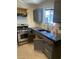 Updated kitchen features stainless steel appliances, dark cabinets and modern finishes at 1651 Cadillac Ln, Las Vegas, NV 89106