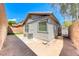 Spacious backyard with gravel and a small patch of grass and two AC units at 173 Calm Morning Ave, Henderson, NV 89002