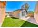 Manicured backyard with lush green artificial turf and a well-maintained patio at 173 Calm Morning Ave, Henderson, NV 89002