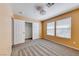 Carpeted bedroom with a walk-in closet, a ceiling fan, and two bright windows at 173 Calm Morning Ave, Henderson, NV 89002