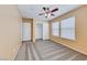 Inviting bedroom with a ceiling fan, closet, carpet, and two windows allowing natural light at 173 Calm Morning Ave, Henderson, NV 89002