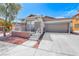 Charming single-story home with desert landscaping, covered porch, and attached two-car garage at 173 Calm Morning Ave, Henderson, NV 89002
