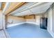 Spacious garage with a refrigerator, blue epoxy flooring and overhead storage at 173 Calm Morning Ave, Henderson, NV 89002