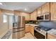Updated kitchen with stainless steel appliances, including a refrigerator and electric range at 173 Calm Morning Ave, Henderson, NV 89002