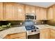 A chef's kitchen boasts updated appliances and granite countertops at 173 Calm Morning Ave, Henderson, NV 89002