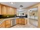 Updated kitchen with stainless steel appliances and modern countertops and adjacent living space at 173 Calm Morning Ave, Henderson, NV 89002