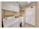Well-equipped laundry room with washer, dryer, sink, and storage cabinets at 173 Calm Morning Ave, Henderson, NV 89002