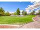 Well-maintained green lawn with mature trees and gravel walkway at 173 Calm Morning Ave, Henderson, NV 89002