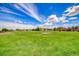 Expansive green lawn and grassy area with sprinklers and a mountain view at 173 Calm Morning Ave, Henderson, NV 89002