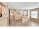 Bright living room featuring neutral paint, tile flooring, and pass-through bar area at 173 Calm Morning Ave, Henderson, NV 89002