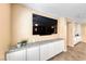 Comfortable living area with ample storage, granite counters, and mounted flat screen television at 173 Calm Morning Ave, Henderson, NV 89002