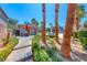 Community pool area with palm trees, lounge chairs, and a covered shower, perfect for relaxation at 173 Calm Morning Ave, Henderson, NV 89002