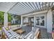 Charming back patio with pergola, patterned concrete and comfortable seating area at 176 Tierra Bonita Ct, Henderson, NV 89074