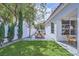 Manicured backyard with artificial turf, dining area and exterior of the home at 176 Tierra Bonita Ct, Henderson, NV 89074