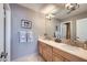 Bathroom features a double vanity with framed mirrors and updated lighting at 176 Tierra Bonita Ct, Henderson, NV 89074