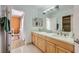 Bathroom features a double vanity with framed mirrors and updated lighting at 176 Tierra Bonita Ct, Henderson, NV 89074