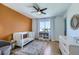 Comfortable Bedroom features a crib, a soft rug, a ceiling fan, and a window at 176 Tierra Bonita Ct, Henderson, NV 89074