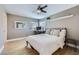 Comfortable bedroom features a large bed, a ceiling fan, wood floors, and a bright window at 176 Tierra Bonita Ct, Henderson, NV 89074