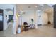 Stylish entryway featuring a chair, textured wall, modern light fixture, and neutral decor at 176 Tierra Bonita Ct, Henderson, NV 89074