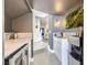 Modern kitchenette with white countertops, beverage cooler, sink, and unique moss art feature at 176 Tierra Bonita Ct, Henderson, NV 89074